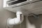 PVC drain pipe connected to an indoor AC unit possibly with a visible blockage